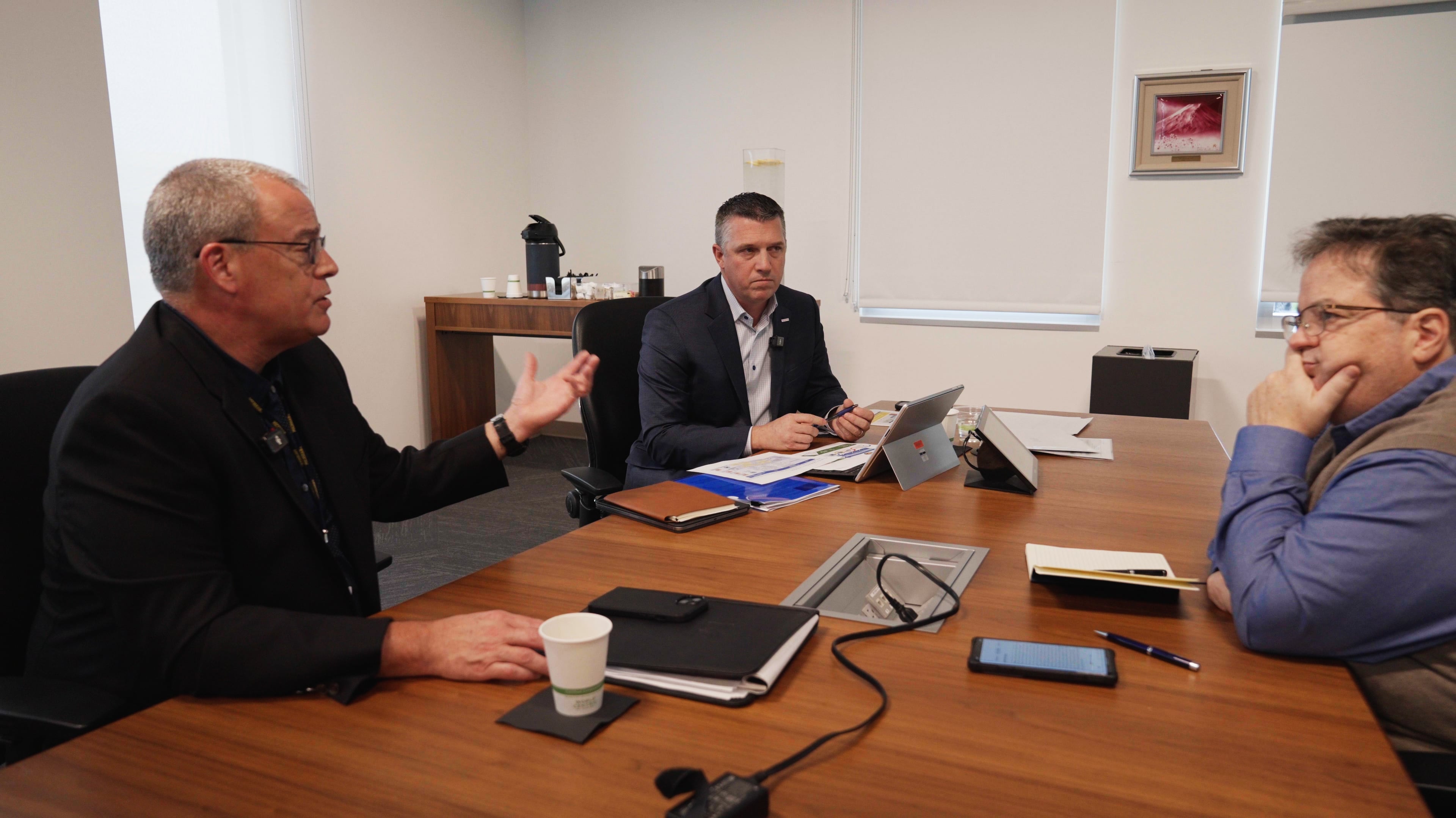 Toyota head of purchasing Bob Young, left,  will retire in March 2025, but his successor, Ryan Grimm, middle, takes over Dec. 1. The two men speak to staff reporter Larry Vellequette near Ann Arbor, Mich., on Nov. 25.